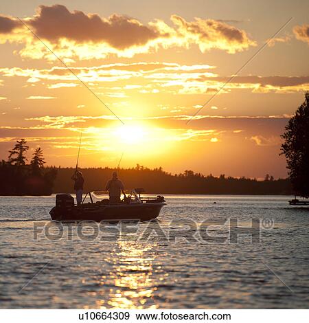 Boat with the sunset sky at Lake of the Woods, Ontario View Large Photo Image Stock Photo - Boat with the sunset sky at Lake of the Woods, Ontario. Fotosearch
