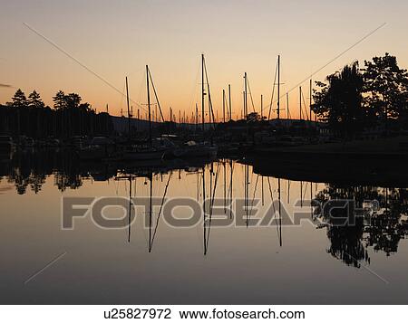 Stock Image - Boats with reflections at the marina in Vancouver, British Columbia, Canada. Fotosearch