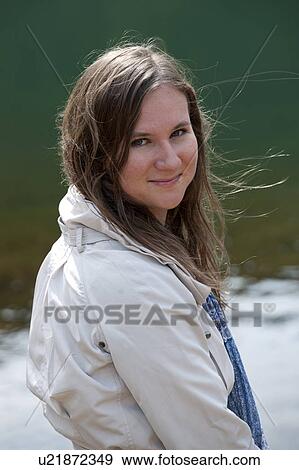 Stock Photo - Brunette teenage girl looking at the camera on location in Iceland. Fotosearch