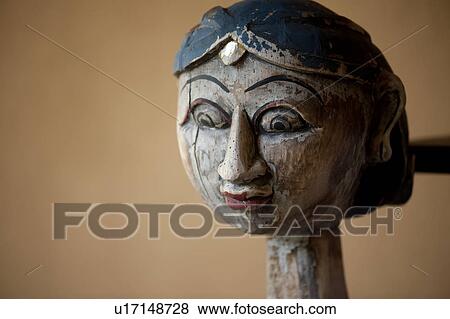 Stock Photo - Carved wooden head of a surprised looking woman with large open eyes and a long neck and a forehead decoration. Fotosearch