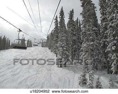 Stock Image - Chair lift on the ski slopes in Vail, Colorado. Fotosearch