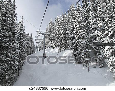 Stock Photograph - Chair lift on the ski slopes in Vail, Colorado. Fotosearch