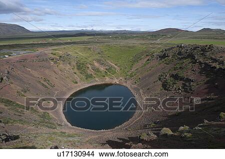 Picture - Circular pool of water in a volcanic crater with green vegetation surrounding. Fotosearch
