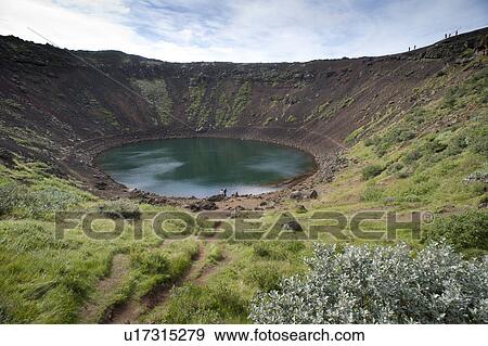 Stock Photo - Circular pool of water in a volcanic crater with green vegetation surrounding. Fotosearch