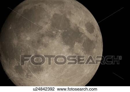 Stock Image - Close up of the moon in the night sky over Lake of the Woods, Ontario. Fotosearch