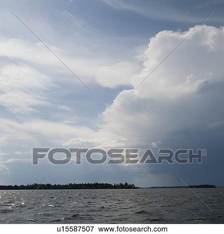 Stock Photo - Clouds in the horizon over Lake of the Woods, Ontario. Fotosearch