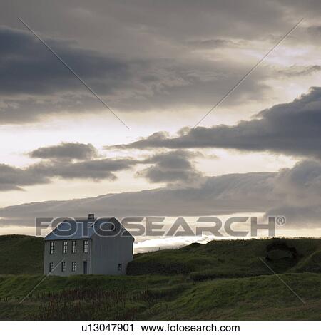 Cloudy evening sky over farmhouse in hilly countryside View Large Photo Image Stock Image - Cloudy evening sky over farmhouse in hilly countryside. Fotosearch