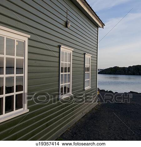Colourful lakeside dwelling with three multi-paned windows drawing perspective towards the horizon View Large Photo Image Picture - Colourful lakeside dwelling with three multi-paned windows drawing perspective towards the horizon. Fotosearch