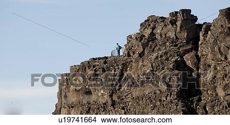 Picture - Craggy mountain look out point, with hiker at rail. Fotosearch