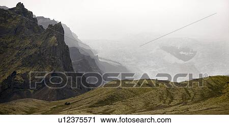 Stock Image - Craggy mountain, misty glacier, rolling hills. Fotosearch
