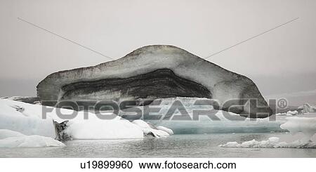 Dirty muddy melting iceberg floating in water View Large Photo Image Stock Image - Dirty muddy melting iceberg floating in water. Fotosearch