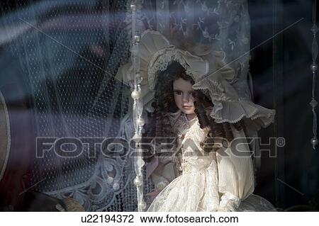 Stock Image - Doll in a window in downtown historic district of Branson, Missouri. Fotosearch