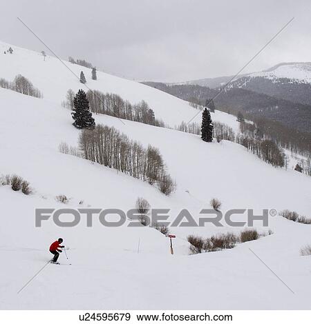 Stock Photo - Dowenhill skier on the slopes in Vail, Colorado . Fotosearch