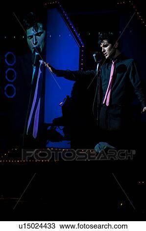 Elvis Presley impersonator performing in Branson, Missouri, U. S. A. View Large Photo Image Stock Image - Elvis Presley impersonator performing in Branson, Missouri, U. S. A.. Fotosearch