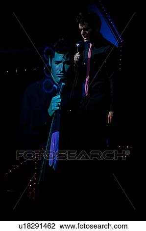 Stock Image - Elvis Presley impersonator performing in Branson, Missouri, U. S. A.. Fotosearch