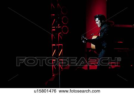 Stock Photograph - Elvis Presley impersonator performing in Branson, Missouri, U. S. A.. Fotosearch