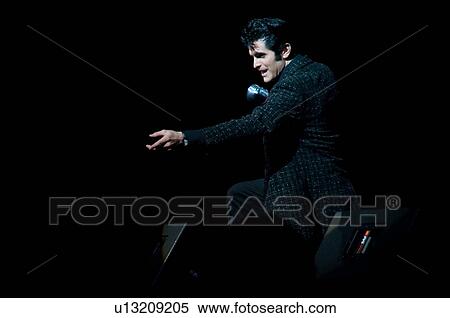 Elvis Presley impersonator performing in Branson, Missouri, U. S. A. View Large Photo Image Stock Photography - Elvis Presley impersonator performing in Branson, Missouri, U. S. A.. Fotosearch