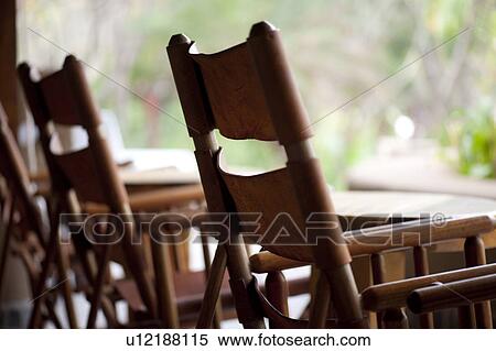 Empty canvas backed wood chairs waiting outside View Large Photo Image Stock Photography - Empty canvas backed wood chairs waiting outside. Fotosearch