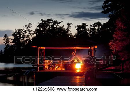 Evening camp fire at Lake of the Woods, Ontario View Large Photo Image Stock Photo - Evening camp fire at Lake of the Woods, Ontario. Fotosearch