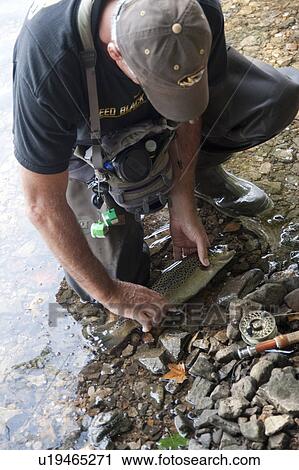 Stock Image - Fisherman at lake Taneycomo in Branson, Missouri. Fotosearch