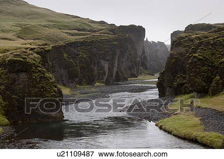 Flat riverbed eroded through the hills View Large Photo Image Stock Photo - Flat riverbed eroded through the hills. Fotosearch