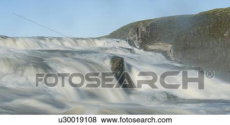 Flowing river cascade past cliff View Large Photo Image Stock Photo - Flowing river cascade past cliff. Fotosearch