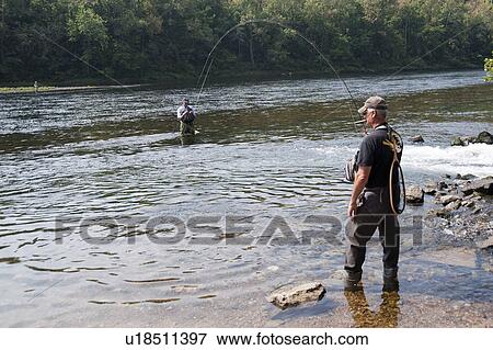 Stock Photo - Fly fishing in lake Taneycomo in Branson, Missouri. Fotosearch