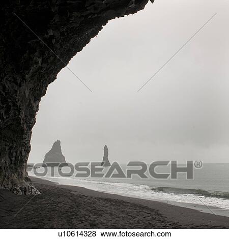 Foggy seascape, framed rock stacks from sea cave View Large Photo Image Stock Photo - Foggy seascape, framed rock stacks from sea cave. Fotosearch