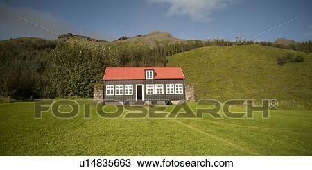 Folk museum with red roof and black siding on grassland before forested hill View Large Photo Image Stock Image - Folk museum with red roof and black siding on grassland before forested hill . Fotosearch