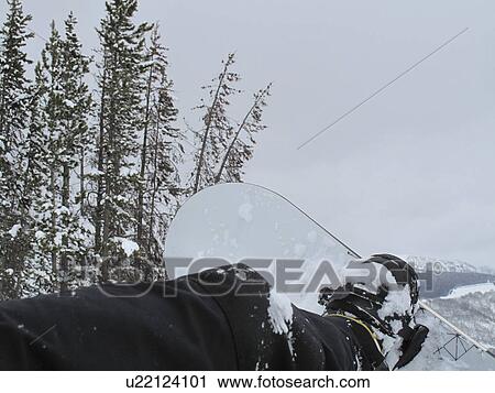 Stock Image - Foot strapped to a snowboard on a ski slope in Vail, Colorado. Fotosearch