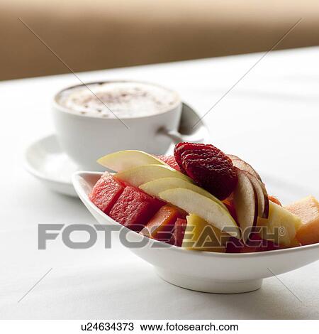 Stock Image - Fresh fruit and cappuccino cup on a table setting in Costa Rica. Fotosearch