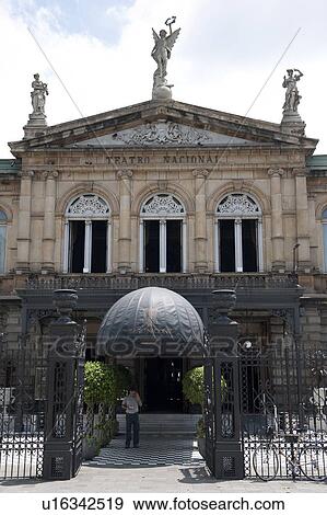 Stock Photo - Front Renaissance facade of National Theatre of Costa Rica with Music, Dance, and Fame statues on the roof, and covered entrance that looks like a big ball. Fotosearch