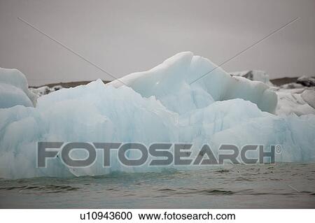 Stock Image - Frozen blue icebergs in a glacial lake. Fotosearch