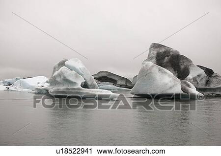 Frozen blue icebergs in a glacial lake View Large Photo Image Stock Image - Frozen blue icebergs in a glacial lake. Fotosearch
