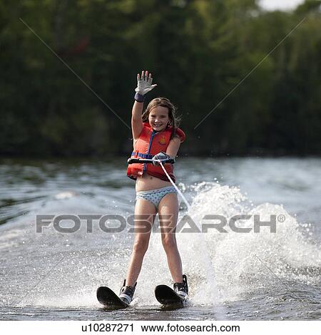 Stock Image - Girl on waterskis at Lake of the Woods, Ontario. Fotosearch