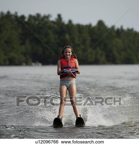 Girl on waterskis at Lake of the Woods, Ontario View Large Photo Image Stock Photograph - Girl on waterskis at Lake of the Woods, Ontario. Fotosearch