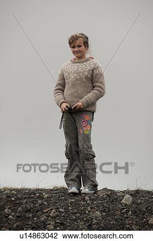 Stock Image - Girl standing alone in Vatnajokull National Park Iceland. Fotosearch