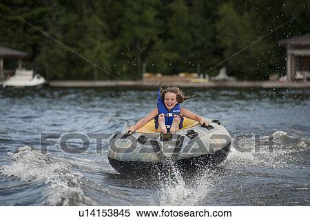 Girl water tubing on the lake at Lake of the Woods, Ontario View Large Photo Image Stock Photography - Girl water tubing on the lake at Lake of the Woods, Ontario. Fotosearch