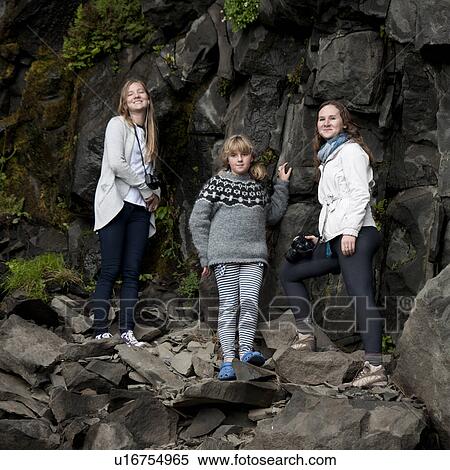 Stock Photography - Girls on rock cliff. Fotosearch