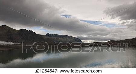 Stock Photo - Glacial mountain coastline. Fotosearch