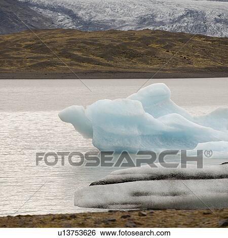 Stock Photograph - Glacier and iceberg in glacial lake. Fotosearch