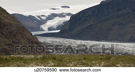 Stock Image - Glacier and terminus in mountain valley. Fotosearch