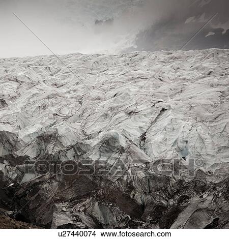 Picture - Glacier ice field in misty mountain valley. Fotosearch
