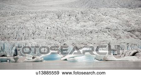Glacier meeting the ocean and icebergs floating View Large Photo Image Stock Photo - Glacier meeting the ocean and icebergs floating. Fotosearch