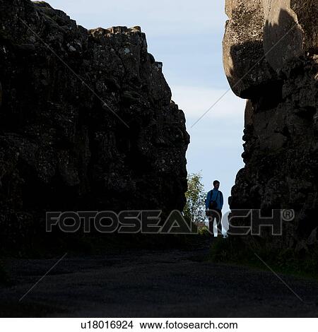 Hiker silhouette between rocky cliffs View Large Photo Image Picture - Hiker silhouette between rocky cliffs. Fotosearch