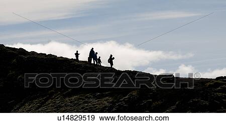 Hikers in silhouette walking down rugged rocky slope View Large Photo Image Stock Photo - Hikers in silhouette walking down rugged rocky slope. Fotosearch