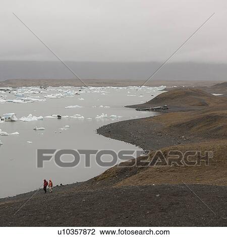Icebergs floating along glacial lakeshore View Large Photo Image Stock Image - Icebergs floating along glacial lakeshore. Fotosearch