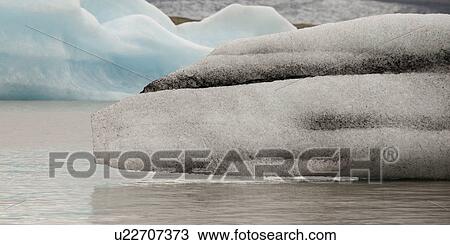 Stock Image - Icebergs floating in the ocean. Fotosearch