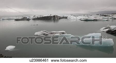 Stock Image - Icebergs floating in the ocean. Fotosearch