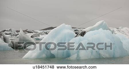 Stock Photo - Icebergs floating in the ocean. Fotosearch